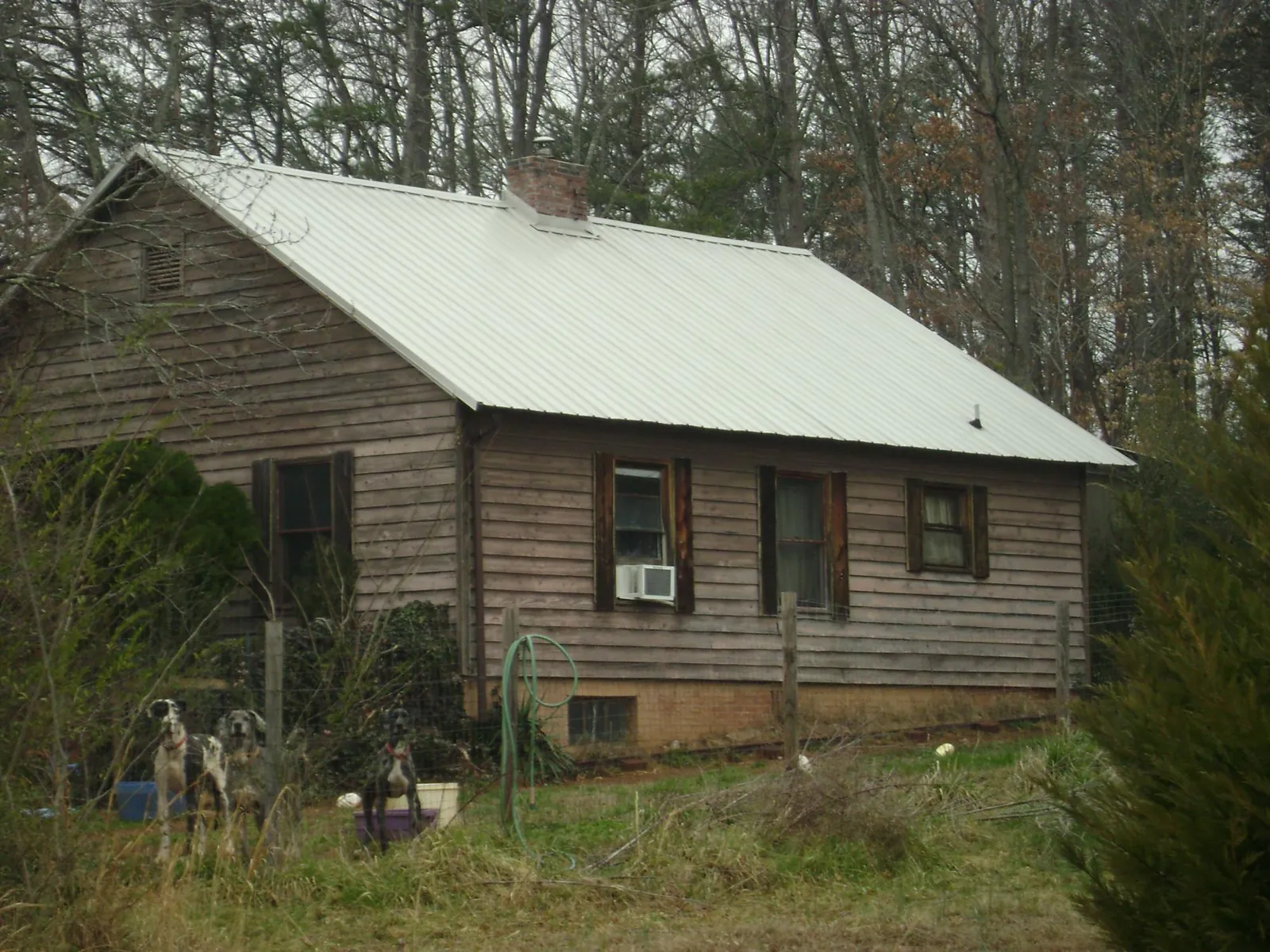 White metal roof on an old wood sided farmhouse, from a Metal Roof Installation job in Comfrey